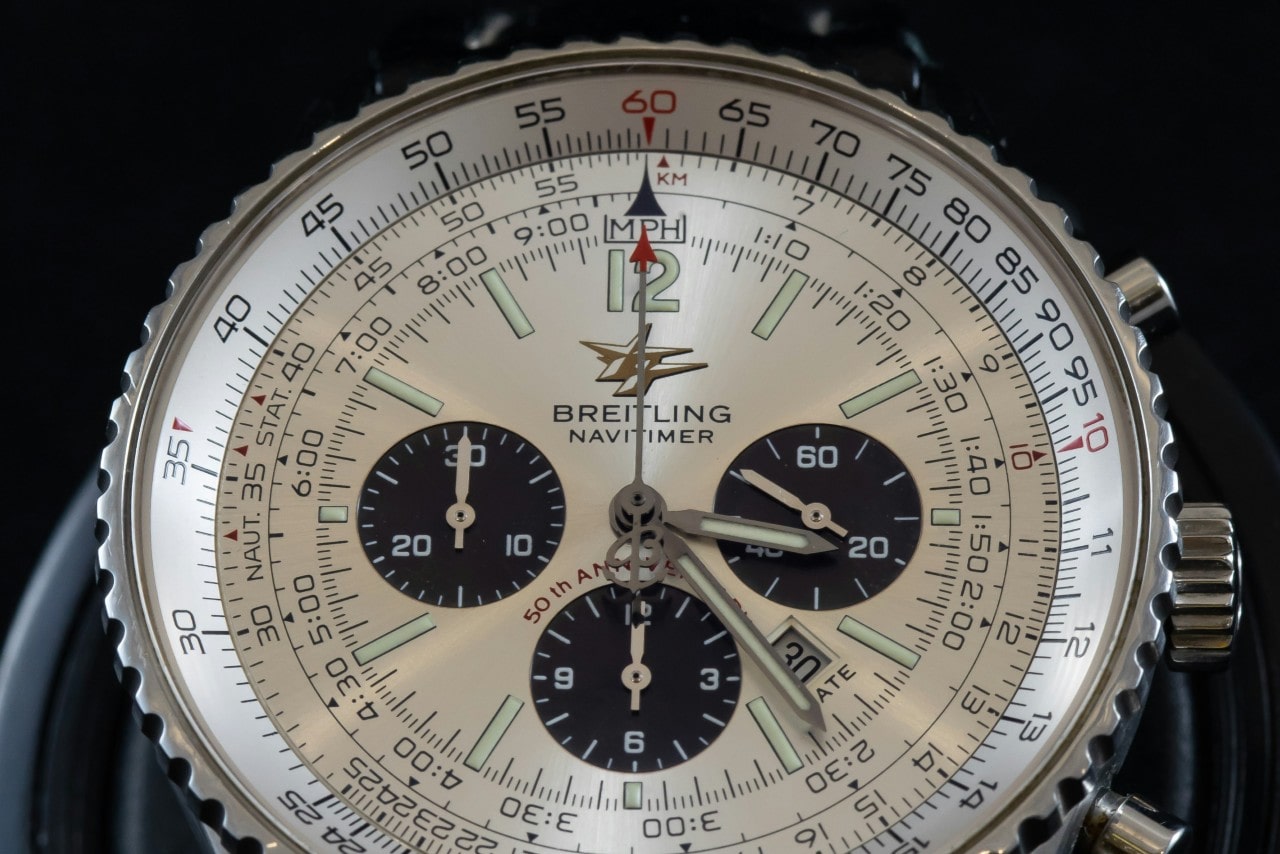 A close-up of a Breitling Navitimer watch with three subdials.