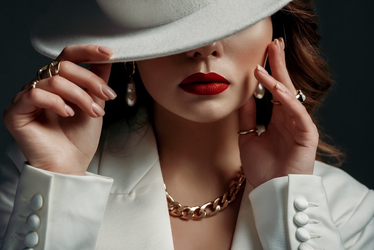 A vintage-styled model wears classic jewelry.