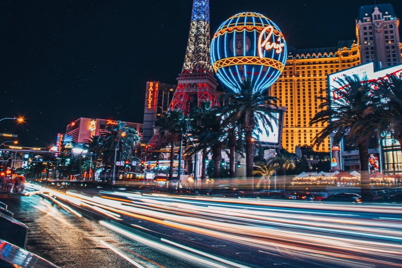 close up image of cars driving by one the Las Vegas Strip