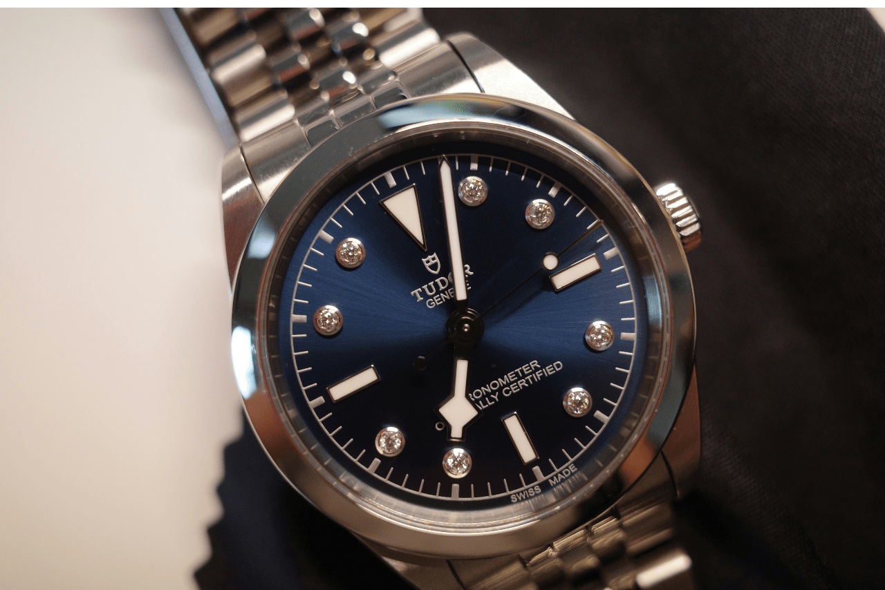 close up image of a TUDOR watch with a polished silver case and strap