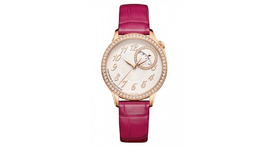 a rose gold watch with a sundial and a red leather watch strap