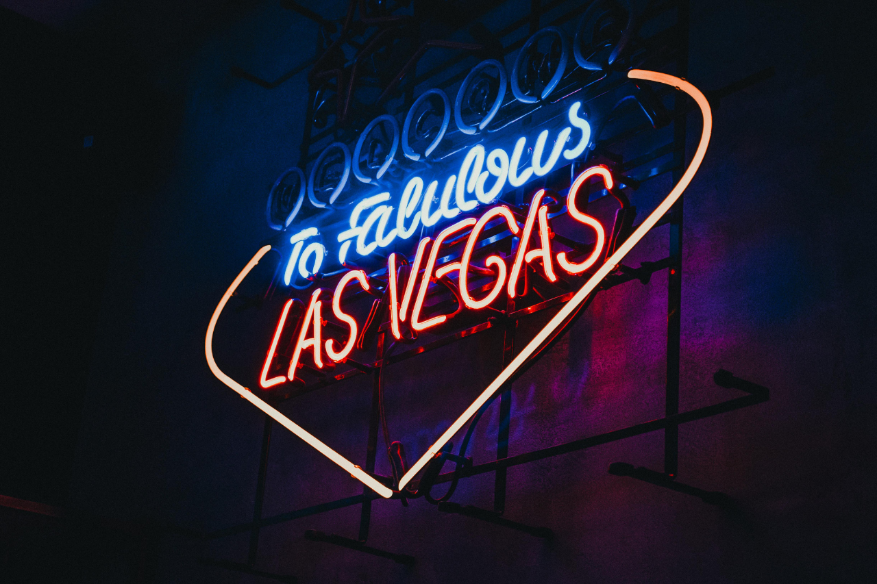A view of a partially lit “Welcome to Fabulous Las Vegas” neon sign at night.