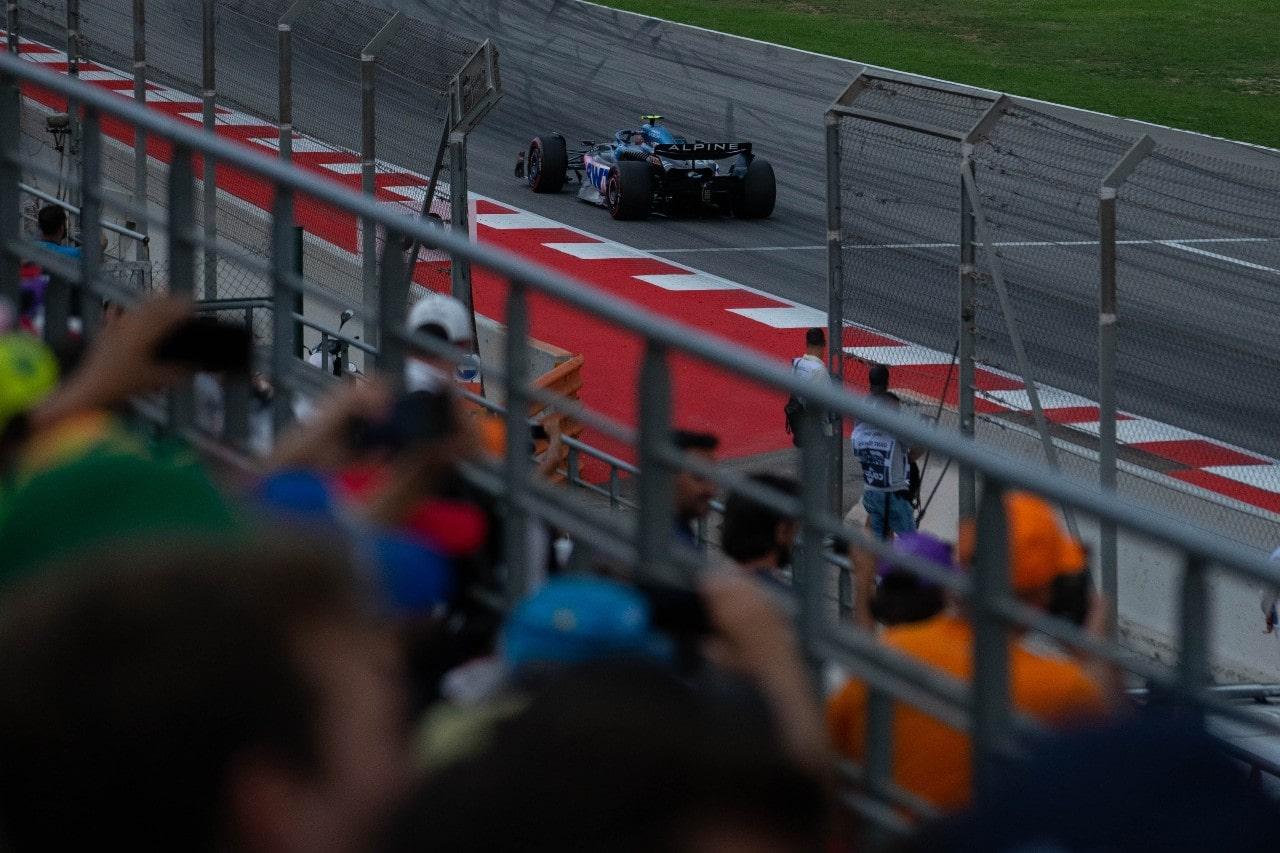 a car on the Formula 1 race track with out of focus crowd