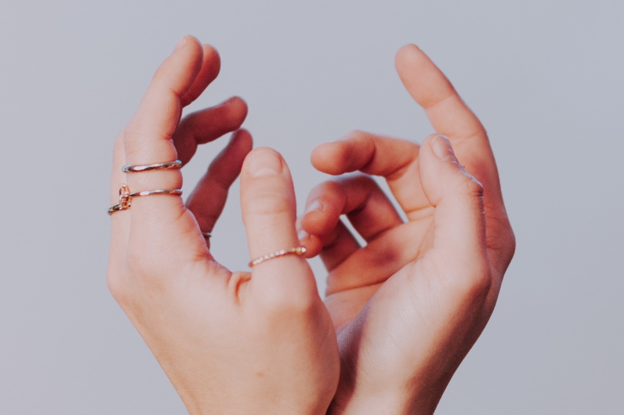 A close-up of a woman’s hands, with emphasis on the multiple rings on her left hand. A close-up of a woman’s hands, with emphasis on the multiple rings on her left hand.