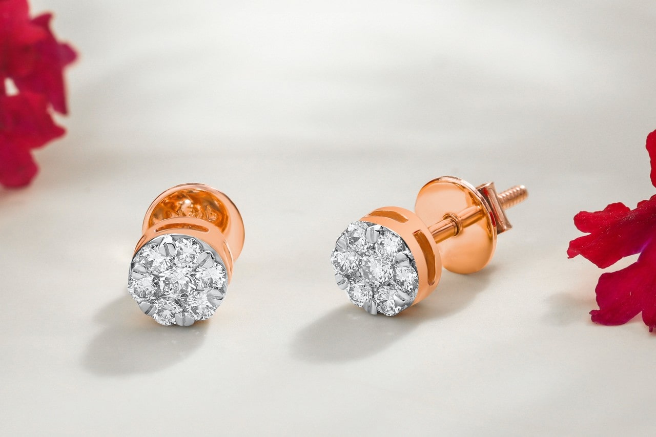 A close-up of a vibrant pair of rose gold diamond earrings